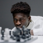 a man in white shirt playing chess